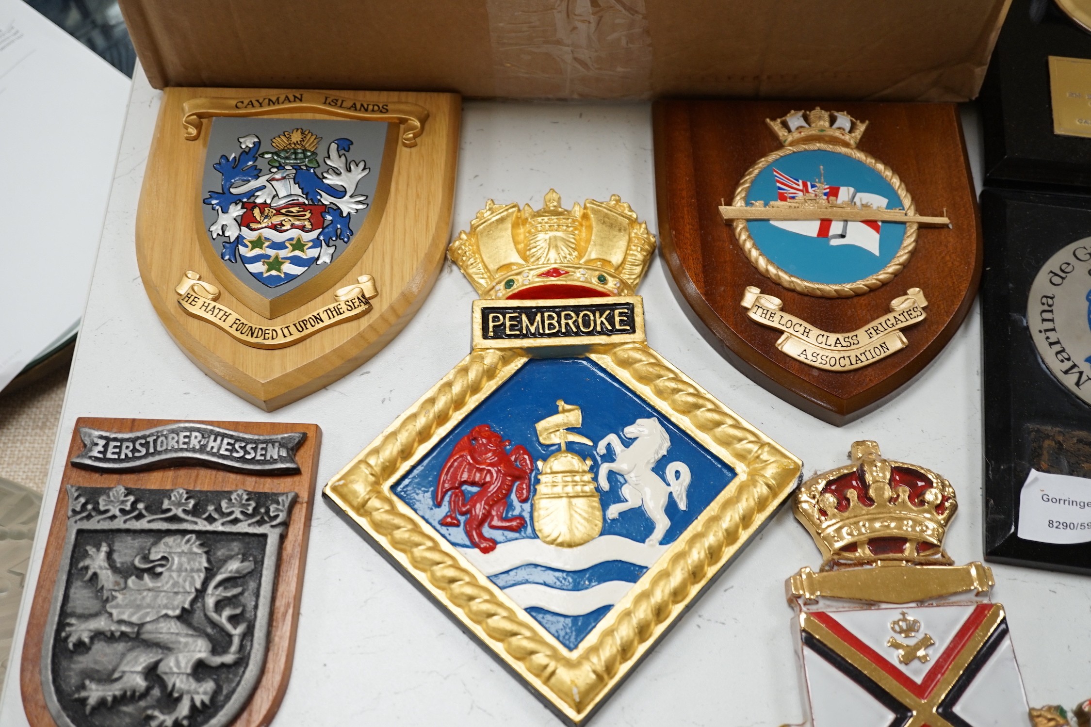 A collection of approximately twenty five plaster and other naval / military and Royal wall hanging plaques
